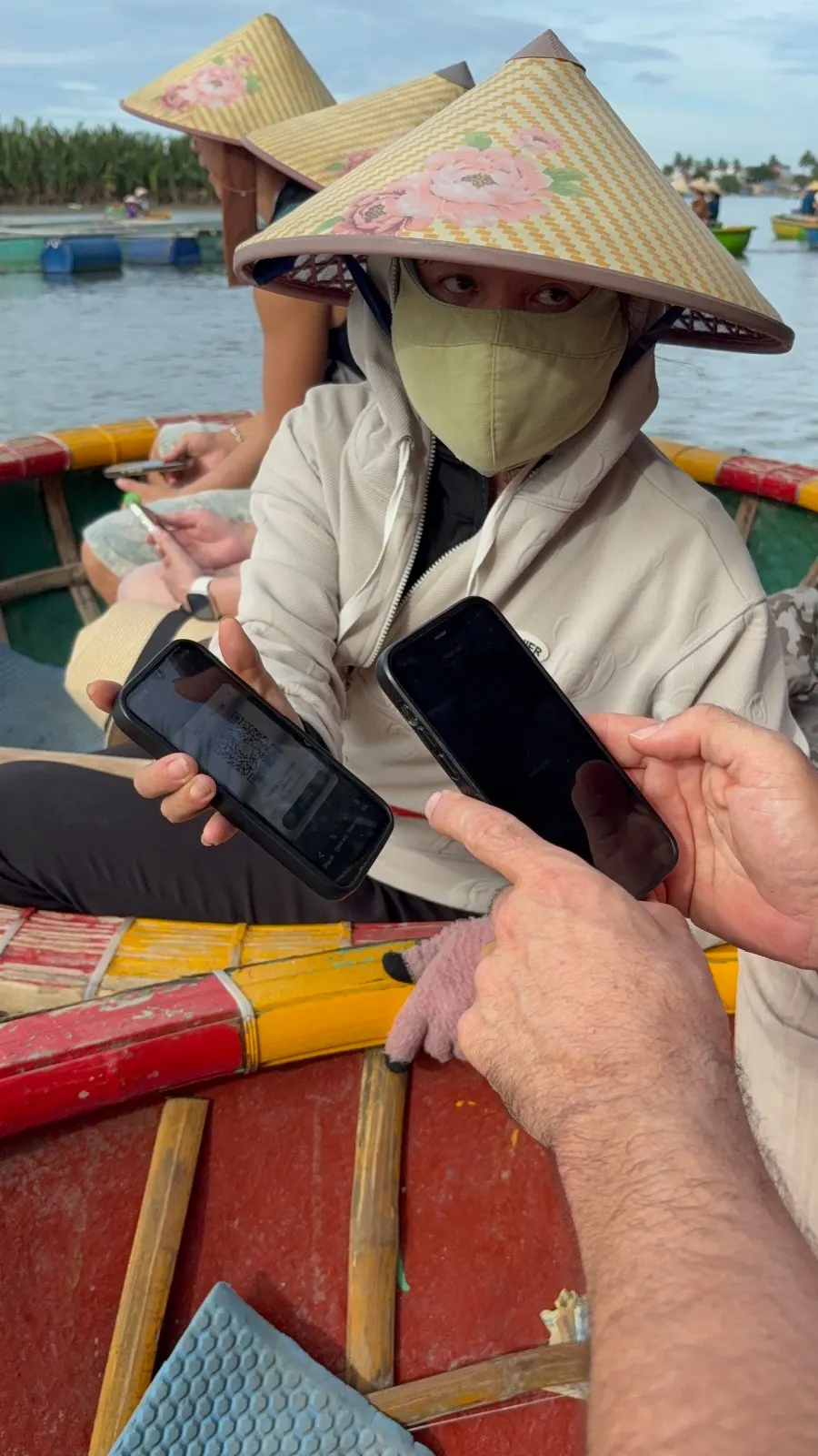 Scanning a VietQR code to pay on the water — Hội An